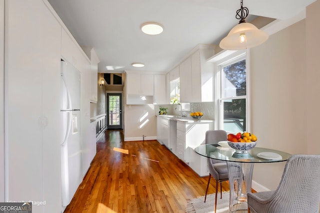 kitchen featuring sink, white cabinetry, white refrigerator, dark hardwood / wood-style floors, and backsplash