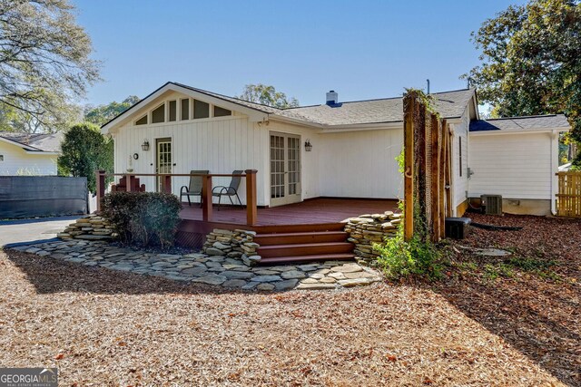 back of house with central AC unit, a deck, and french doors