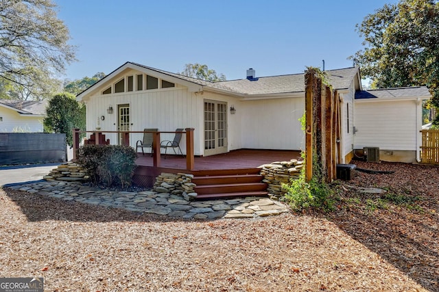 rear view of property featuring a wooden deck