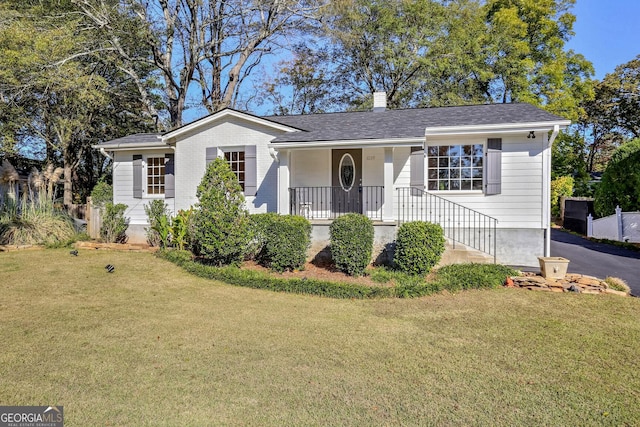 single story home with covered porch and a front yard