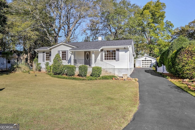 view of front facade featuring a garage, an outdoor structure, a front yard, and covered porch