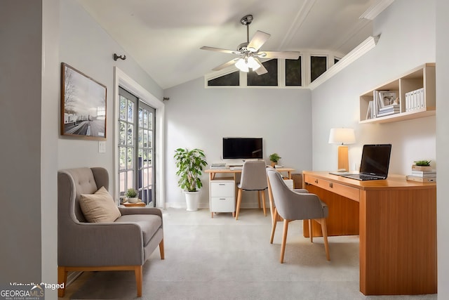 carpeted home office featuring ceiling fan, built in desk, and vaulted ceiling