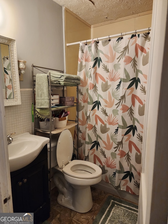 bathroom featuring a textured ceiling, tile walls, toilet, vanity, and a shower with shower curtain