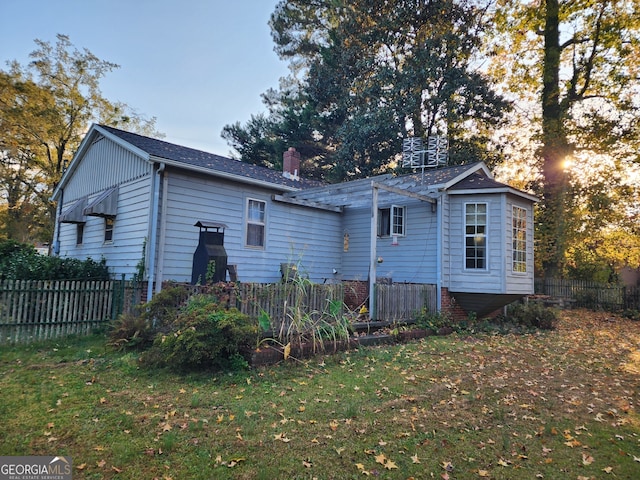 back of property featuring a yard