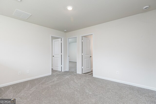 unfurnished bedroom featuring light carpet