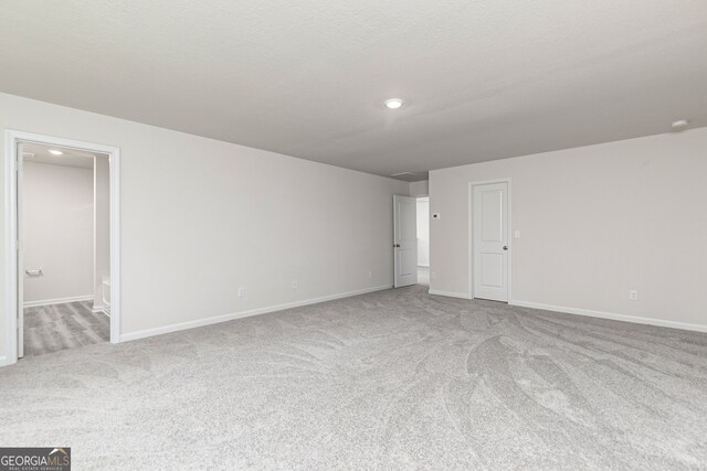 carpeted spare room featuring a textured ceiling