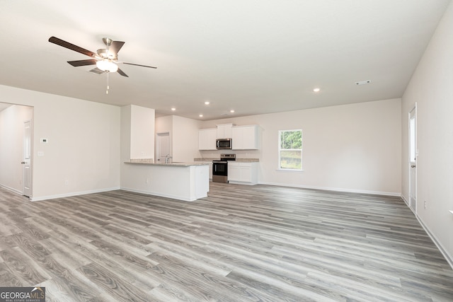 unfurnished living room featuring light hardwood / wood-style floors and ceiling fan