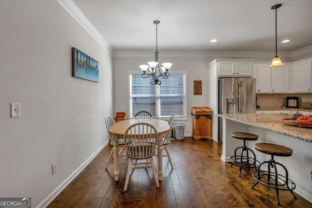 dining space featuring crown molding, a notable chandelier, and dark hardwood / wood-style flooring