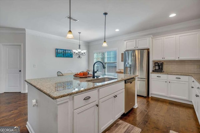 kitchen with dark hardwood / wood-style floors, white cabinets, sink, and an island with sink