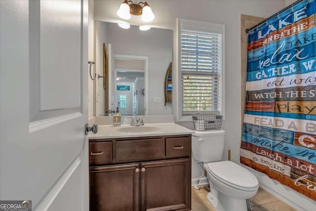 bathroom with vanity, toilet, a notable chandelier, and tile patterned flooring