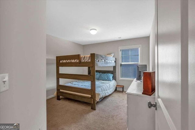 bedroom featuring light colored carpet