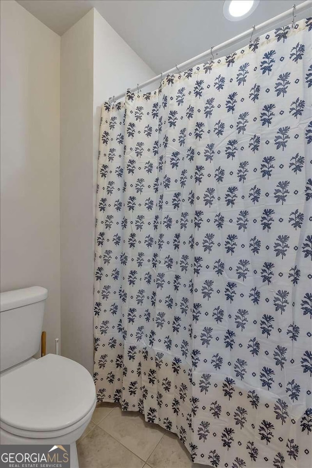 bathroom with tile patterned floors and toilet