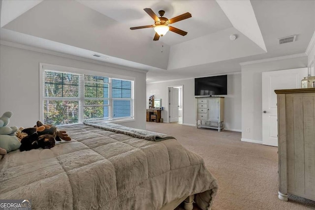 bedroom featuring ornamental molding, carpet floors, a tray ceiling, and ceiling fan