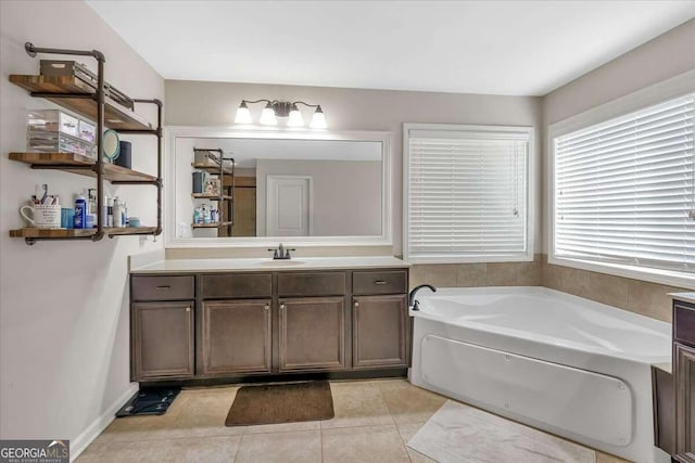 bathroom featuring vanity, a tub, and tile patterned flooring