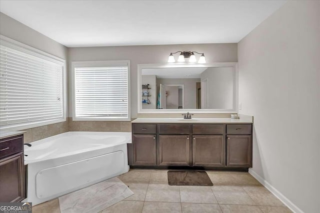 bathroom featuring vanity, tile patterned flooring, and a bathing tub