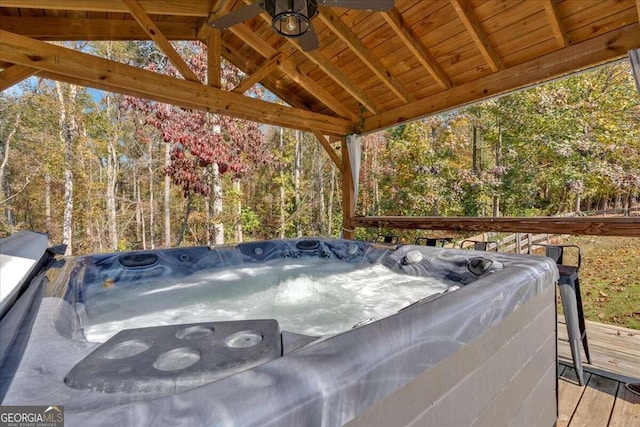 view of patio featuring a wooden deck and a hot tub