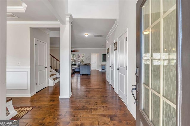 entryway featuring ornamental molding, ornate columns, dark hardwood / wood-style floors, and ceiling fan