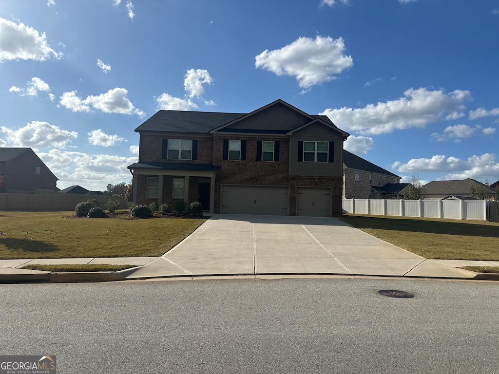 view of front of property featuring a front lawn and a garage