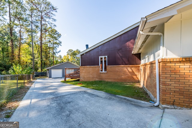 view of side of property featuring an outbuilding and a garage