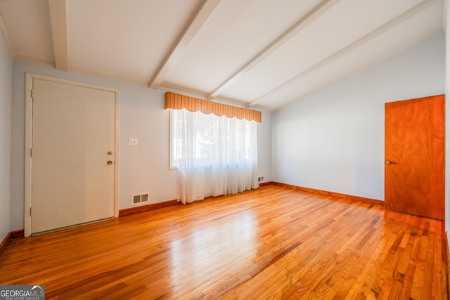 interior space with lofted ceiling with beams and light wood-type flooring