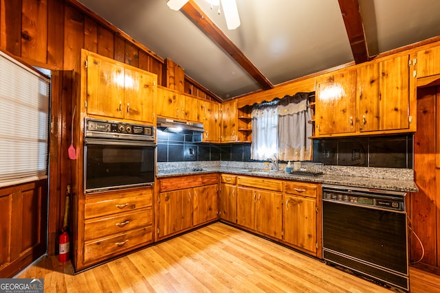 kitchen featuring vaulted ceiling with beams, wooden walls, light hardwood / wood-style flooring, sink, and black appliances