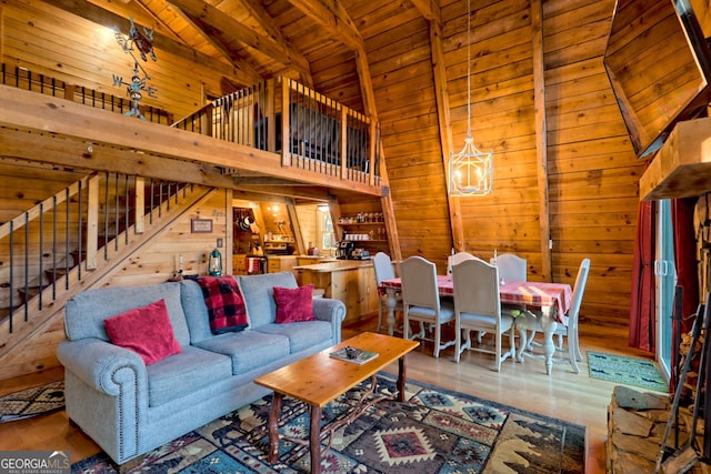 living room featuring wood ceiling, wood walls, hardwood / wood-style flooring, and high vaulted ceiling