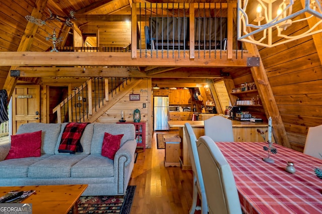 living room featuring wood ceiling, wood walls, wood-type flooring, and vaulted ceiling with beams