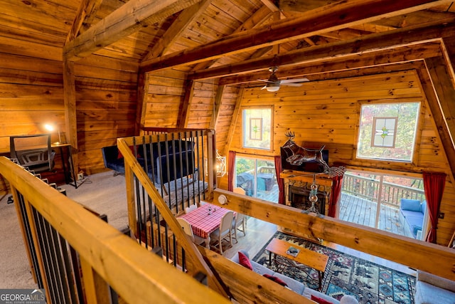 interior space with lofted ceiling with beams, wooden ceiling, and wooden walls