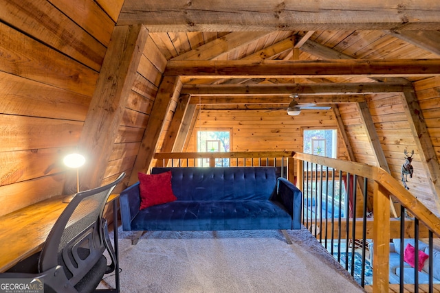 sitting room with wood ceiling, lofted ceiling with beams, carpet, and wooden walls