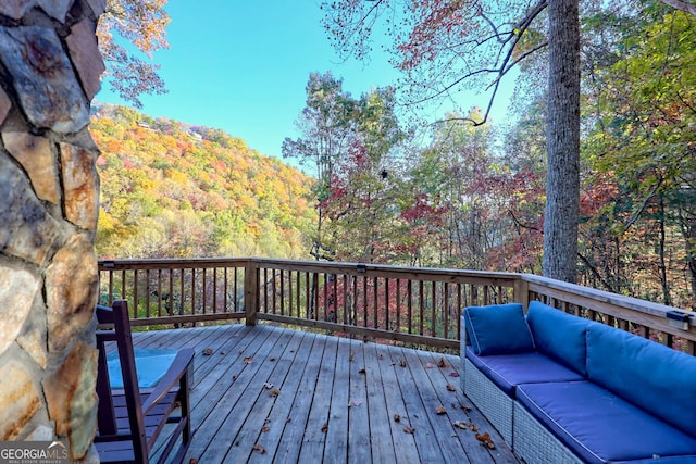 wooden terrace featuring an outdoor hangout area