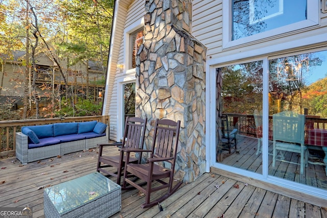 wooden terrace with outdoor lounge area