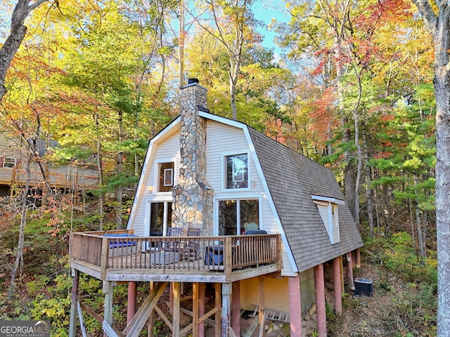 back of house with a wooden deck and central air condition unit