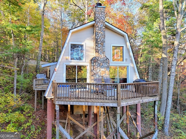 back of house with a wooden deck