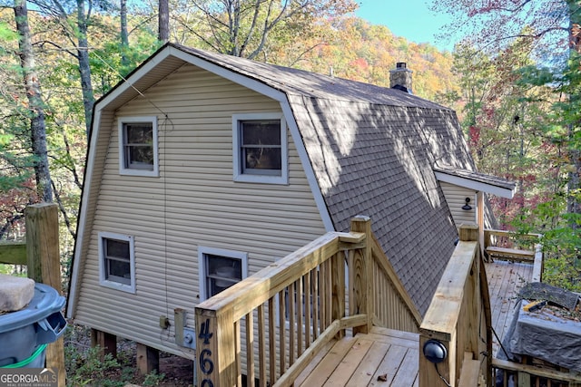 rear view of house with a wooden deck