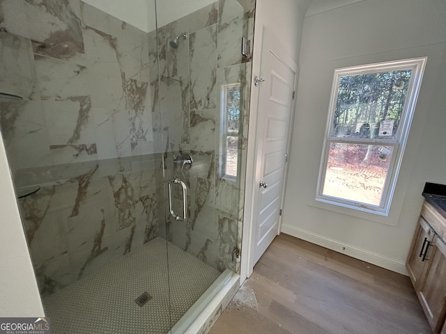 bathroom with vanity, an enclosed shower, and wood-type flooring