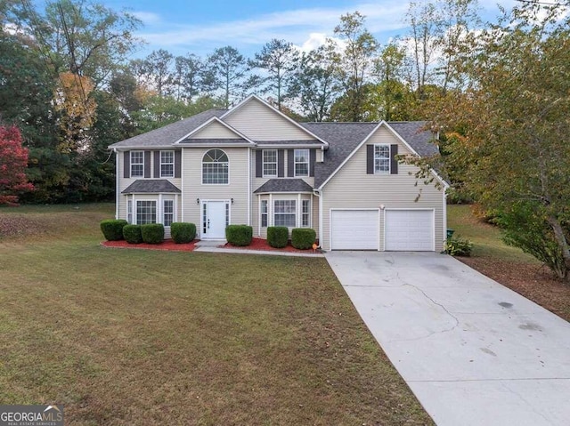 view of front of home featuring a front yard and a garage