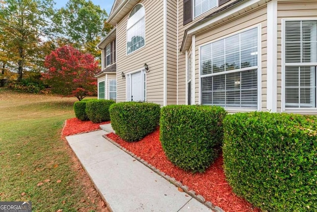 view of property exterior with a lawn