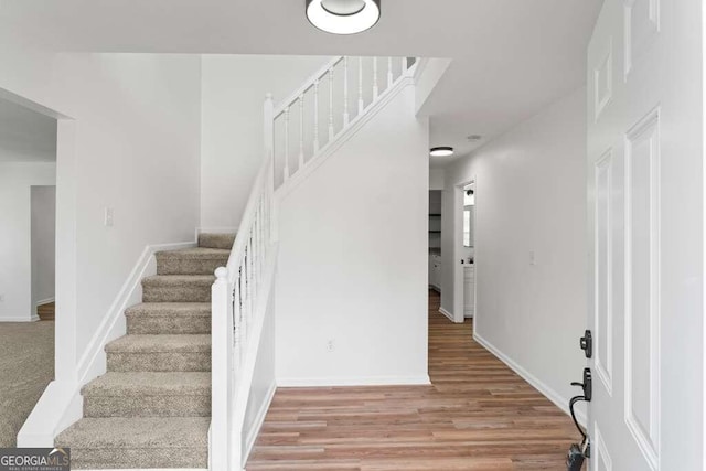 staircase featuring hardwood / wood-style floors