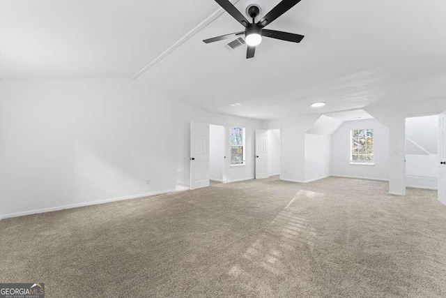 interior space with light carpet, lofted ceiling, and ceiling fan