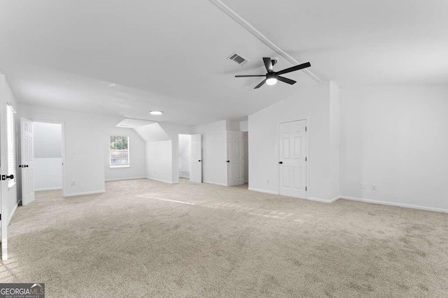 bonus room with lofted ceiling, light colored carpet, and ceiling fan