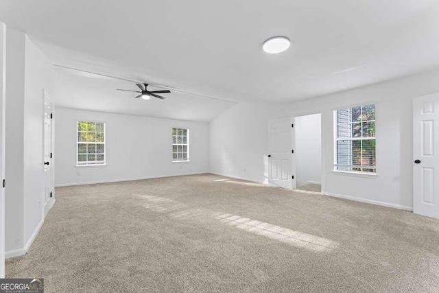 unfurnished room with light colored carpet and ceiling fan