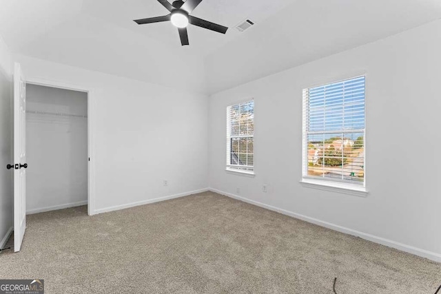 unfurnished bedroom featuring light colored carpet, a closet, and ceiling fan