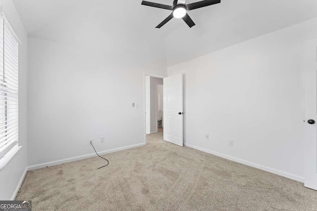 carpeted spare room featuring ceiling fan