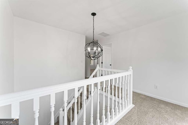 room details featuring a notable chandelier and carpet floors