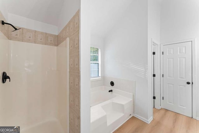 bathroom featuring wood-type flooring and independent shower and bath