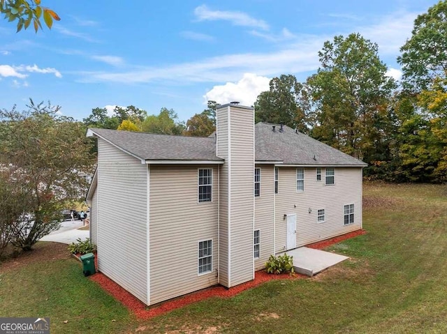 rear view of house with a lawn