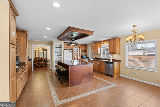 kitchen with sink, a kitchen island, stainless steel appliances, light tile patterned floors, and an inviting chandelier