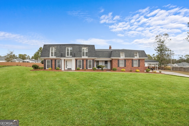 new england style home featuring a front lawn