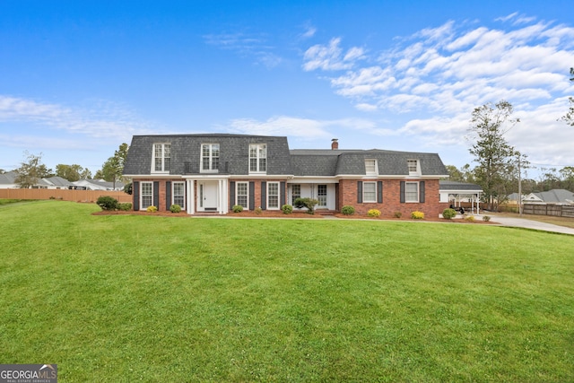 402 Brannen Dr, Statesboro, GA 30458 - view of front of property featuring brick siding, mansard roof, concrete driveway, and a shingled roof