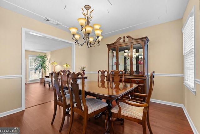 402 Brannen Dr, Statesboro, GA 30458 - dining area featuring a chandelier, wood finished floors, and baseboards